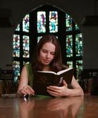 Student reading in a library